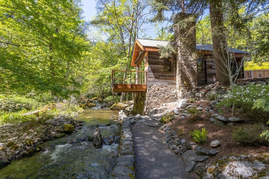 Adjacent to almost 300' of Ashland Creek, this property is arguably the most breathtaking piece of real estate Ashland has to offer. Bordered on 3 sides by Lithia Park, the privacy and exclusivity is like no other. The lush .87 acre property is fully landscaped with rock walls, crushed gravel walking paths, perennial flower beds, mature trees, and fabulous moss covered boulders. There are two cottages on the property. The newly constructed 396 square foot Millhouse features a deck that overlooks Lithia creek. There is also a 220 square foot studio/office space. The property is ready for your dream home and the Sellers are happy to share their designs for an architecturally pleasing home. Truly a once in a lifetime opportunity.