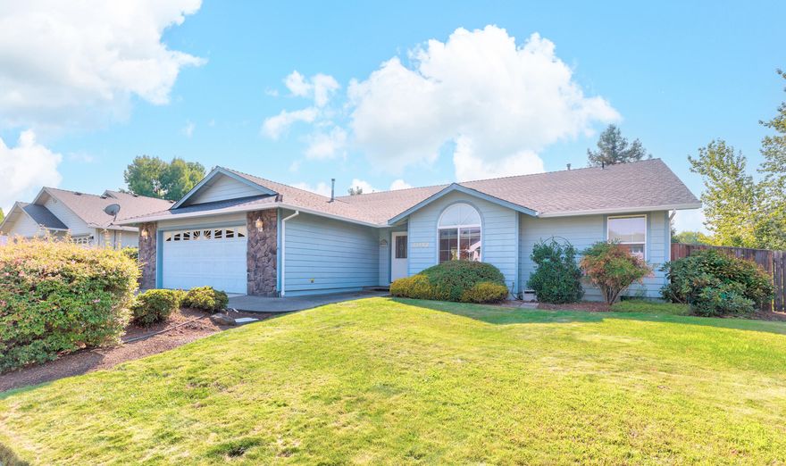 Located in a quiet Grants Pass neighborhood, 2052 Nebraska Ave is a 3 bedroom, 2 bath single story home designed for comfort and ease. Vaulted ceilings and expansive windows bring in natural light, creating an inviting and spacious feel. The thoughtful floor plan flows seamlessly from the living area to the kitchen and dining spaces, making it ideal for both everyday living and entertaining. Mature landscaping adds charm and privacy to the property, with a backyard ready to enjoy as it is or customize to your vision. Conveniently situated near schools, shopping, and town amenities, this home offers a blend of practicality and character in a sought-after location.