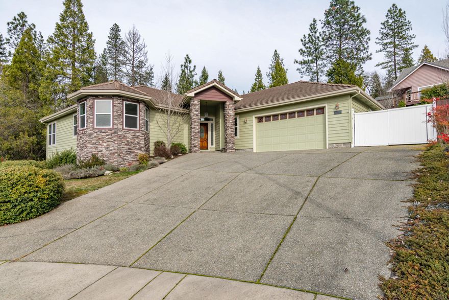 Gorgeous custom home located in culdesac with mountain views! 2697 s/f with 3 bdrm 2.5 bath plus a den on large .32 acre lot.   Open floor plan offers oodles of space for comfortable living and entertaining. Custom designed kitchen featuring hickory cabinets, granite counters, gas range, convenient breakfast bar and more.  Wrap around bay window lends a casual grace to the breakfast nook that features extended views of the valley. A 3-sided gas fireplace adds warmth to the living and formal dining rooms. Spacious Master bedroom with two-sided fireplace graces this master suite retreat.  Den could easily be converted to 4th bdrm.  Outdoors, features covered deck for evening enjoyment plus a private backyard professionally landscaped.  A greenhouse and raised garden beds for the gardener in the family. The side yard adjoins a private wooded lot.  BONUS: over 300 s/f of storage under the house as well as an extra deep garage with room for shop and storage. RV parking