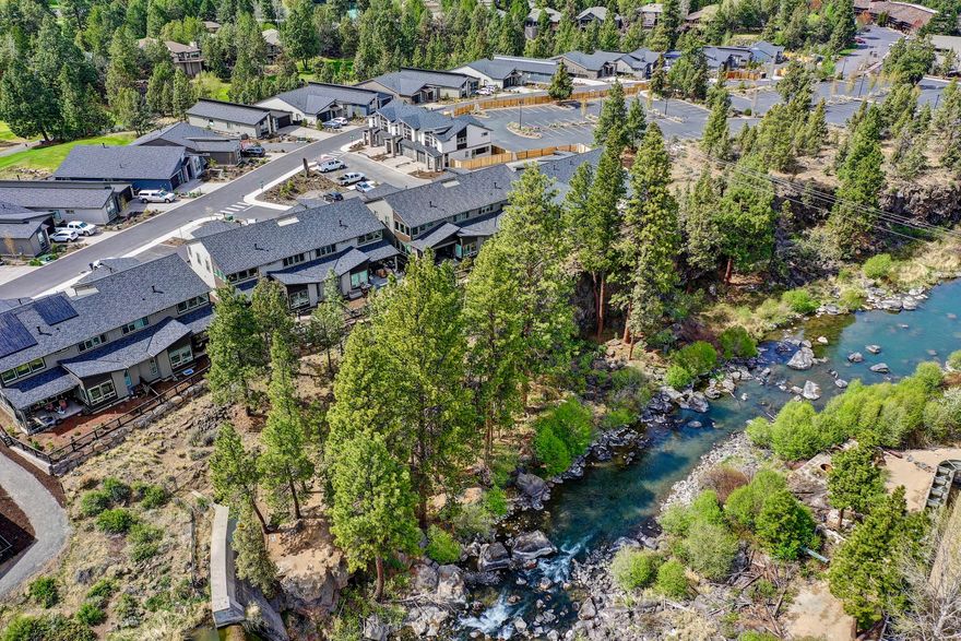 This distinguished townhome on the Deschutes River in NW Bend offers views and soothing sounds of the falls. The well-designed plan includes a 2-story vaulted great room with riverfront patio access, primary suite and office with custom built-in cabinetry on the main level and a second suite, additional spacious bedroom and bathroom, and loft w/wet bar upstairs. The kitchen boasts quartz countertops, under cabinet lighting, soft close drawers and cabinet doors, and high-end stainless appliances. The main-level primary suite has river view and riverfront patio access and spa-like bath with freestanding soaking tub, tiled shower, and custom California Closets system. The 2-car garage with epoxy floor accommodates a large truck and the extra-long driveway and guest spots in front ensure ample parking while entertaining. The Pointe is located 2 miles from downtown and includes private river access and front yard landscaping and townhome exterior maintenance covered by the HOA.