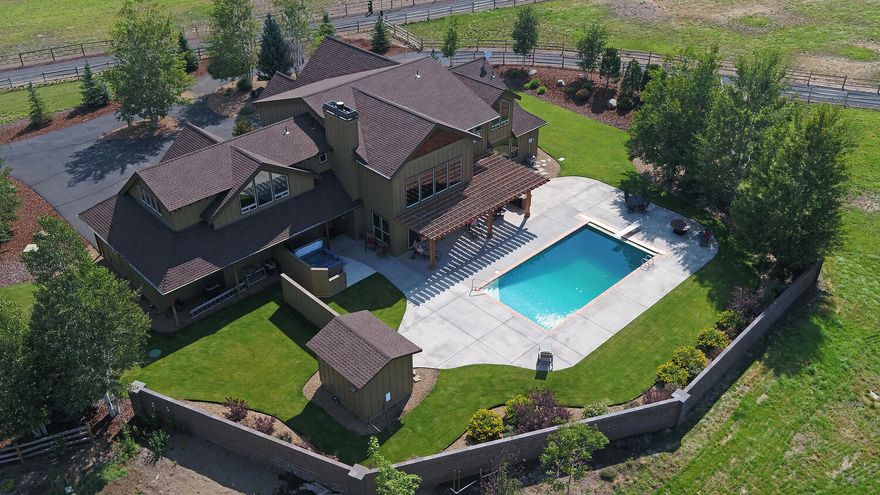 Beautifully appointed Sisters ranch on 9.75 ac w/ spectacular Cascade views! Spacious western patio w/ private swimming pool, spa, heated outdoor waterfall shower, & covered pergola seating offers a perfect warm & cold weather oasis. Immaculate 5 bedroom, 3.5 bath home w/ bonus room, formal dining, office & main floor primary suite. Enjoy wonderful open concept living, w/ chef's kitchen & west facing living room for big mountain views. Custom details throughout include beautiful knotty white oak hardwood floors, artisan Alder cabinetry & floor to vaulted ceiling stacked stone gas fireplace.  Situated perfectly w/ established trees & landscaping, cross-property split rail fencing delineates multiple pastures maintained by in-ground irrigation. 3 acres of perfected ground-irrigation rights, makes it a wonderful horse property or lush hobby farm for generations. 4,200 sf finished shop space means endless opportunities & toy storage with plenty of room to have it all!