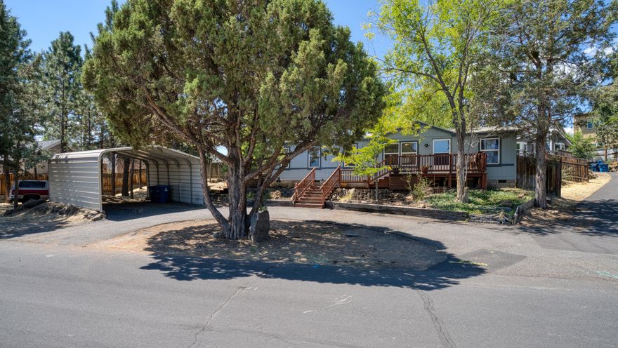 Whether you're searching for a large lot on city services or need room to build a shop or adu, this parcel offers it. The home sits off to one side, providing the freedom to design your next ambition exactly as you see fit. This gem is situated on a quiet street in NE Bend that sees very few passing vehicles. Accessible AND peaceful settings like this are difficult to find. The single level home reflects years of loving care and is great condition. The lot size also presents the opportunity to remove the manufactured home and partition into multiple parcels. RS zoned. See engineering photos in MLS for land division ideas.