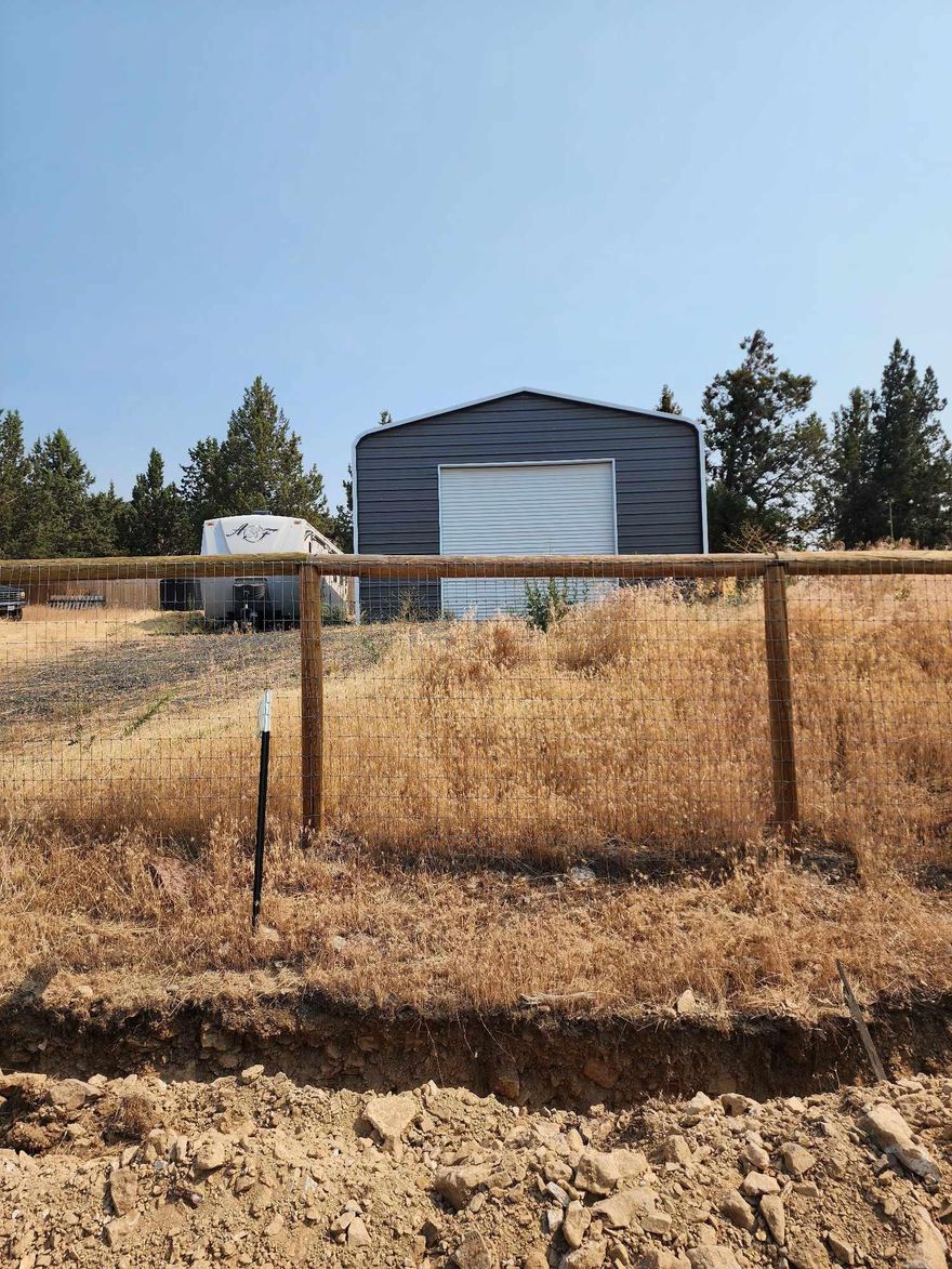 WOW! only $109,000.  Price has been slashed! Seller wants it sold today! Gorgeous homesite with mountain and valley views and a large recently built 24ft X 41 FT Shop finished with a beautiful paver floor. There is a new perimeter woven wire/wood fence. The site has been cleared, the road put in, an RV pad installed, and septic feasibility completed. The water meter has been installed. Come play where you live. There are 1200 acres of community land. If that's not enough for you the subdivision also adjoins the BLM. You are sure to love all the miles of trails accessible for hiking, biking, horseback riding and ATV riding. Cool off in the swimming pool, plan your events and gatherings at the club house,  Go fishing in the lake. Pop off a round in the shooting range. There are even horse stables. Do not miss your chance to have it all . Call today and make your dreams come true at a price nearly unheard of.