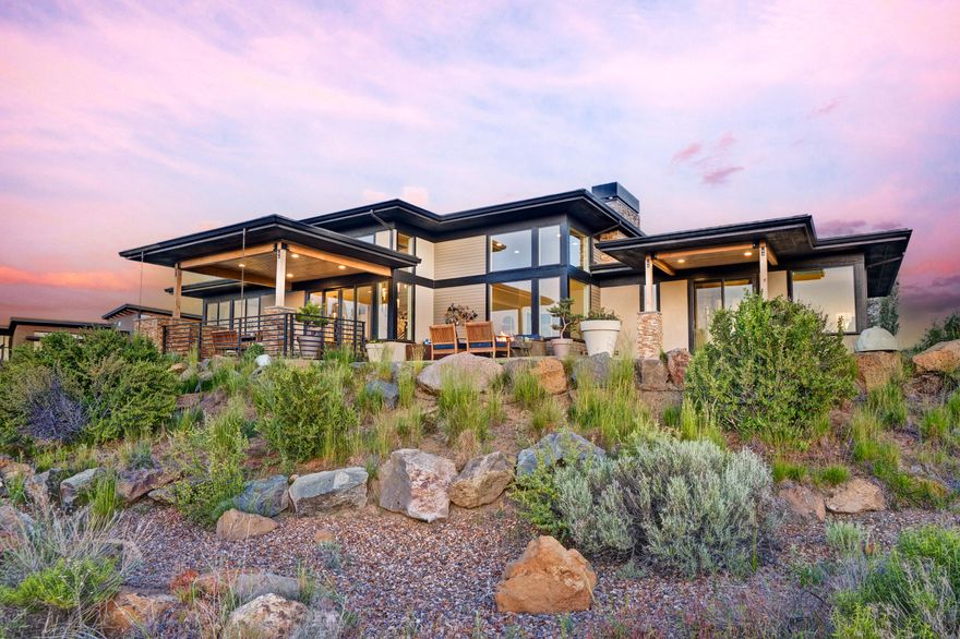 This contemporary Tetherow home blends refined design with everyday access to Bend's best recreation. Framed by sweeping Cascade views, it features large windows, engineered hardwoods, and soaring ceilings. The great room centers on a gas fireplace and corner windows that frame the mountains, flowing into a dining area and chef's kitchen with quartz counters, a 48'' Miele range, double ovens with steam options, and an expansive pantry. The main-level primary suite includes a spa-like bath and private patio, while upstairs offers a large bonus space, flex room, and two full guest suites. Thoughtful extras include an office, generous mudroom, large laundry, and a 3-car garage with shop space. Backing to open space with direct trail access, and just minutes to downtown Bend, Mt. Bachelor, and the Cascade Lakes, this home pairs quiet elegance with world-class resort living. Buyer is responsible for social or golf membership.