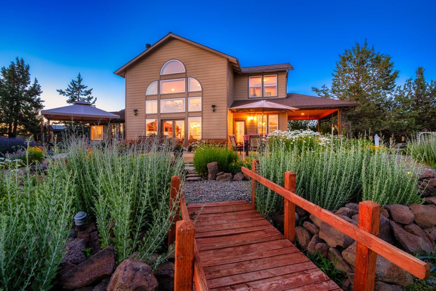 Welcome to your dream home! Nestled on 5.21 acres, this property provides a serene escape with panoramic 360-degree Cascade Mountain views, capturing mesmerizing sunrises and sunsets.  3 bdrm, 2.5 bath, 2395 sq ft home features floor-to-ceiling picturesque windows in the Great room.  Primary suite on the main level offers a large soaking tub & fireplace. Spacious kitchen boasts modern appliances,  2 bdrms upstairs includes a loft for added space & versatility. All rooms are bathed in an abundance of natural light with captivating views.  Meticulously maintained gardens showcase diverse flora and fauna. Private walking paths for tranquil strolls, along with thoughtfully designed outdoor spaces for relaxation & gatherings. Also featuring an expansive 24x40 shop with 2 additional rooms, providing ample storage, workspace & RV parking.  This home is energy-efficient, boasting a private well and solar power. Don't miss the opportunity to own this amazing home surrounded by nature's beauty.