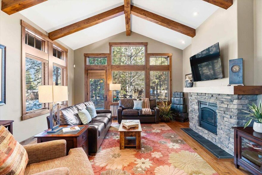 Introducing a beautiful single level Sun Forest cabin located in the highly sought after community of Caldera Springs! You'll be welcomed at a spacious front porch with barbeque. Inside you will find vaulted ceilings, knotty alder cabinetry throughout, hardwood floors, large windows, timber accents and a stone fireplace. The primary suite is on one side of the home and 2 additional en-suites on the opposite side with a 4th full bath off the great room. Enjoy your summer evenings on the outdoor paver patio, featuring a hot tub. The location is at the core of all of the community activities w/ easy access to bike trails, the Lake House and Quarry Pool. Owners will enjoy Caldera Springs living with access to all existing and forth-coming amenities, including golf, Quarry pool & fitness, bike and kayak rentals, and the highly anticipated Forest House opening Summer 2024. Fully furnished with an established rental history. Singe car garage & A/C. Don't miss this one!