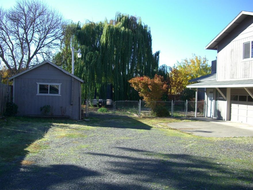 What a buy!! Lots of space for all the toys ect. Large 1/3 acre flag lot with 30 foot wide access. So much to enjoy in this tri-level home with over 1900 sq. ft. 3 bd 3 bath. Living room views the front yard and has a wood stove insert in fire place. Tile floor in large kitchen. Master suite is a comfortable size. Fenced yard includes shade trees and raised garden beds. RV and boat parking.