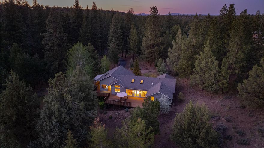 *NEW PRICE* The Bend dream can be yours in this ultra private two acre lot near the Deschutes River Trail. Enjoy the peace and serenity of nature out your door, yet you're only minutes to schools, shopping and all the popular amenities the westside offers. The vaulted ceilings, skylights and tons of windows create a sense of peace and tranquility. With just under 2000 SF, the home lives large with three bedrooms, two full bathrooms, a living room and a family room. Five exterior doors enhance your outdoor living on the huge wraparound deck. Lots of natural space around the home provides a privacy buffer. Fences and detached shop buildings are allowed with HOA approval. The 1000 SF garage has plenty of room for all your toys. There is one flight of stairs up from the garage as well as a few steps to the primary bedroom, otherwise it's main level living in this northwest style home. Your new home awaits, come see it today