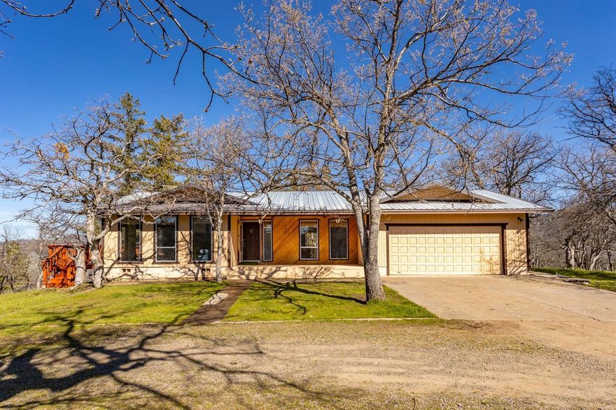 Enjoy breathtaking mountain views, looking down on the city of Ashland and Mt. Ashland in the distance from this private retreat! This 3 bed, 3 bath, 1652sqft home sits on over 12 acres with partial irrigation & RV parking with full hookups. The home welcomes you into an open living room with exposed hand cut wood beams, new carpet, wood stove, an abundance of natural light plus views of the city below! The spacious kitchen features an eat-in bar, plenty of cabinet space and a large pantry. The large Master Bedroom offers abundant closet space, full bath with a walk-in shower, additional storage and access to the covered back patio. The two additional bedrooms are roomy and offer ample closet space. The second living area features newer laminate flooring and access to the patio & 2 car garage. This home also offers a newer HVAC system and all new gutters! Come see this beautiful property today!