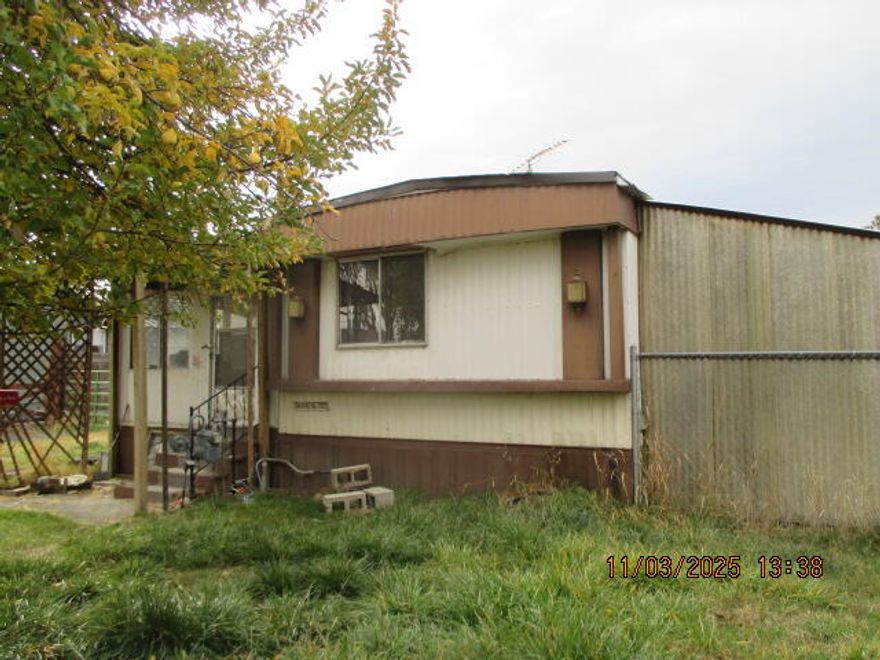 Owner financing available for those with approved credit. The half-acre lot, combined with all utilities, makes it a convenient choice for potential buyers. The added features, like the 800 sq ft shop with concrete flooring, provide ample space for various uses, be it for storage, a workshop, or hobbies. The fact that the older mobile home can be moved or renovated gives buyers flexibility in how they want to use the space. Fenced property on 1/2 acre, fruit trees are a lovely bonus that can contribute to a charming outdoor space. A great spot for someone who enjoys a bit of country living but still wants access to modern conveniences. 
Property is sold 'as-is'.  New electric service to pole. City water is available with the requesting of new meter.