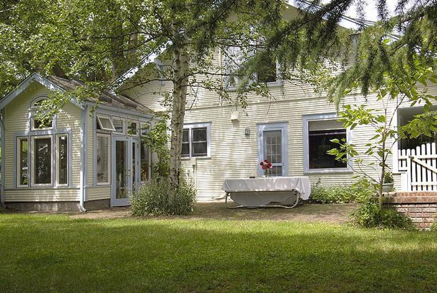 Very Private home nestled in the heart of the Railroad District, one block from Main Street. Beautifully landscaped with brick patio. The home is equipped with all the extras-upgraded appliances, skylights, a steam shower, sun room off the kitchen and wood floors throughout. There's also room for another unit-check with the City. The property is truly exquisite both inside and out.