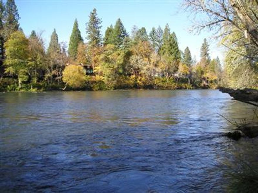 Unbelievable river lot with city amenities. Large .57-acre lot with 96-feet of useable riverfront property. Property is level with beautiful river and mountain views. Property is ready for your new river home in desirable Shady Cove.