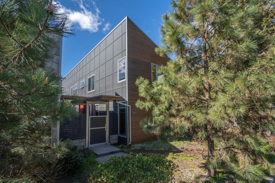 In the heart of Bend's westside corridor and moments from shopping, restaurants, bike trails & parks right out your front door. The home features radiant heat concrete floors, solid wood doors, non-toxic cabinetry, gas appliances & fireplace, solid wood countertops. Second floor master allows for a tree top living with a private patio, walk-in closet, and large bathroom with a pop of color in the bathroom. This home has ample storage in this home, plus a 1+ car garage. Mature landscaping and outdoor fireplace makes this the perfect location to call home.