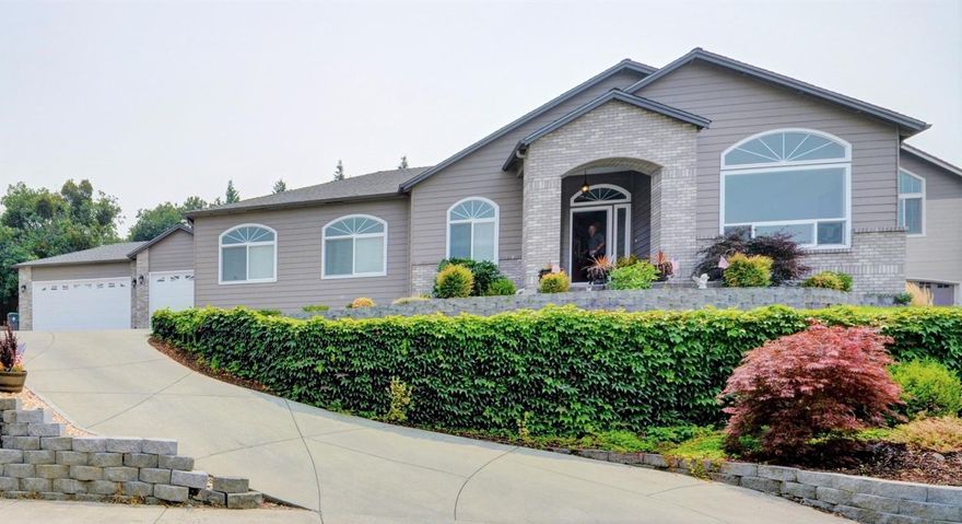 Views Galore!! Beautiful, one owner single-level home in East Medford. 3 bd/2 ba w/office, 2219 sqft. Custom tile work throughout, gas fireplace, fire pit, water feature & 3 car garage. New carpet, new hardwood in office. Formal dining room off of the kitchen. Fresh paint inside and out. Both bathrooms have been completely redone w/new cabinets, new tile, walk-in closet and heated floors in the master bath. Terraced yard with mature landscaping, low voltage lighting, rock walls and built in BBQ; this home was built for entertaining! You can see city lights, vineyard, orchards and mountains, all while sitting in your front room. Must see! This home is move in ready!