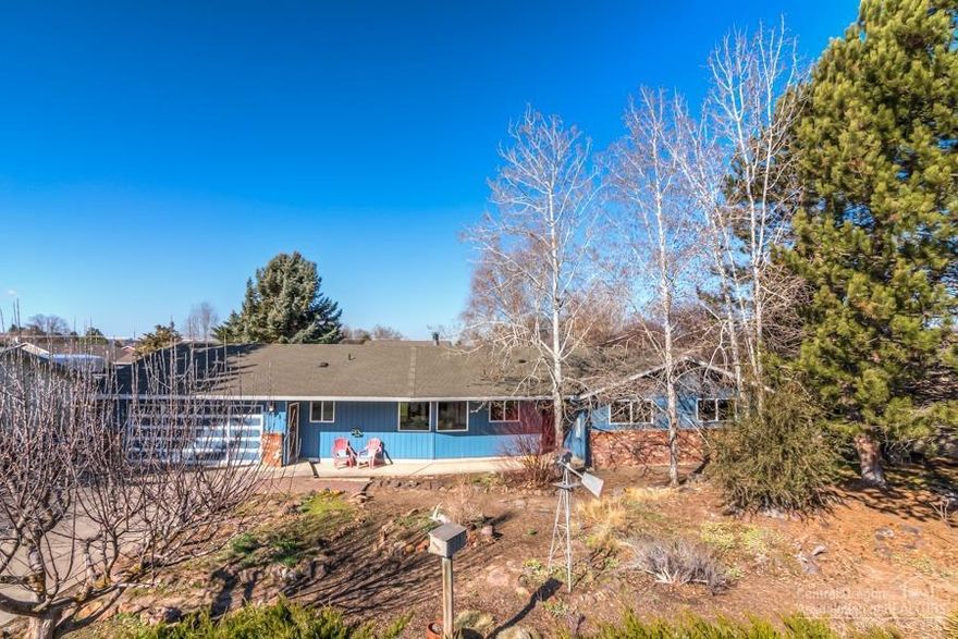 Charming single story on beautiful .46 acre lot in Prineville! 3 bedroom, 2 bath, 1684 sq ft with two living spaces. Unique brick entryway. French doors into living room. Updated kitchen with recessed lighting, Corian counters with tile back splash, hardwood floors, & pendant lights. Cozy wood stove in step down family room with vintage brick surround. Enjoy those summer nights in your lush back yard with raised beds, play area, tree house, and hot tub. Not your average cookie cutter. Charm and character throughout! New water heater 2020, heat pump 2016, and ready for it's new family!