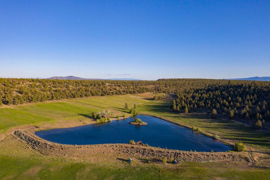Incredible opportunity to own one of the most spectacular ranching and recreational properties in Central Oregon nestled in a private little valley of your own. Turn key cattle / horse operation, 138 acres with 63 acres of irrigation using buried lines and pop up sprinklers, fenced pastures, hay barn, and a shop. 6 acre lake is ready for your own private fishing, hunting, or water sports passions. A large pavilion with manicured lawn sits on the edge of the lake inviting your guests to celebrate the amazing view and sunsets next to the fire pit. Borders thousands of acres of BLM land. A 2 bed 2 bath manufactured home is on the property with electrical power to a new build site. Live in the existing home while you build your dream. 20 minutes from Sisters and 40 minutes from Bend. Only 30 minutes from the Redmond airport.  Ask listing broker for extensive property info. book.