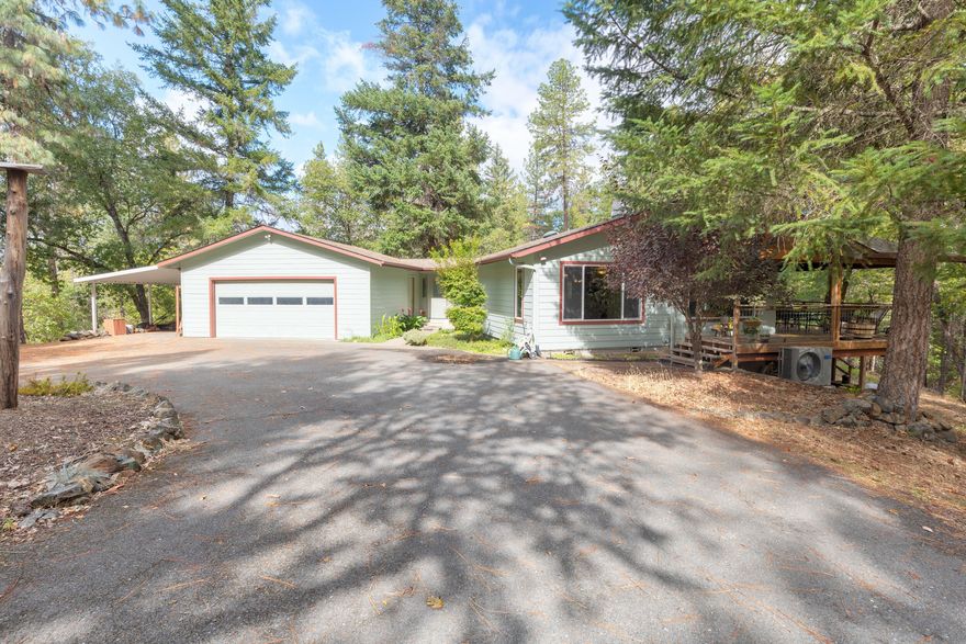 Private Retreat at the End of the Road! Tucked away in a serene, wooded setting, this charming 3-bedroom, 2-bath ranch-style home offers the perfect blend of privacy and convenience. 
Step out from the open and bright kitchen/dining area onto a covered deck and savor your morning coffee surrounded by nature, all with minimal yard maintenance. The spacious two-car garage includes a utility room for laundry and additional storage. The paved driveway features a convenient turnabout for easy access.
A standout feature is the detached shop, previously used as a woodshop. Attached is a beautifully finished studio space with abundant natural light and a Murphy bed—perfect for guests, hobbies, or a quiet workspace (no plumbing in studio).
If you're seeking peaceful seclusion without sacrificing comfort, this property is a must-see. Home, Well, and Septic inspections on file. Seller has made several repairs.