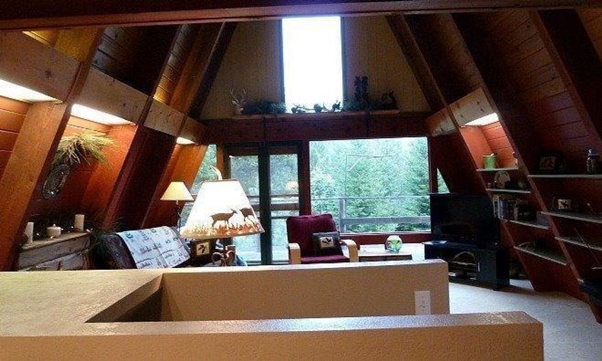 On almost 20 acres this is a charming updated A-frame, on a paved road surrounded by nature. A flowing year round creek is a short walk below the house. There is also a wonderful yard with a koi pond. The kitchen was updated 4 years ago with new windows, granite counter tops, sink, appliances, and flooring. The newly completed guest bath remodel looks fantastic with new tub surround and glass doors, new toilet, sink, counter tops, cabinets and flooring. The down stairs is heated with its own heat monitor with separate living area and master bedroom & bath. The 24x36 two car plus garage with shop has 10 foot ceilings on a concrete foundation and a RV roll up door. There is tons of storage and a work area. Included are a 10x10 green house and a 10x16 out building. The million dollar views are worth the tour of the property. Location is close to the Upper Rogue River and national forests. The property is hardship ready with its own power meter.