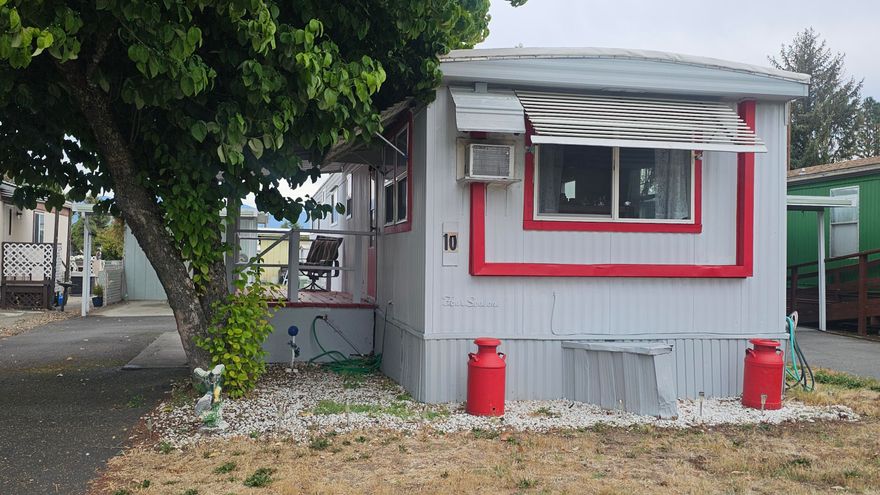 Nestled in a quiet 55+ community, this cute, 720 sf manufactured home is ready for a new owner!  This 2 bed/1 bath home was built in 1972 and has a nice flow, as well as plenty of natural light throughout!  Outside, enjoy the covered front porch and lifetime rubberized roof. There is a nice, covered carport with paved parking and a storage shed. All appliances are included with the sale. The flooring could use replacing throughout.  Home being sold As-Is.  The lower space rent includes water, sewer, and garbage!  With easy access to shopping and medical facilities, don't miss out on this opportunity to make this home your own!  Cats are allowed.