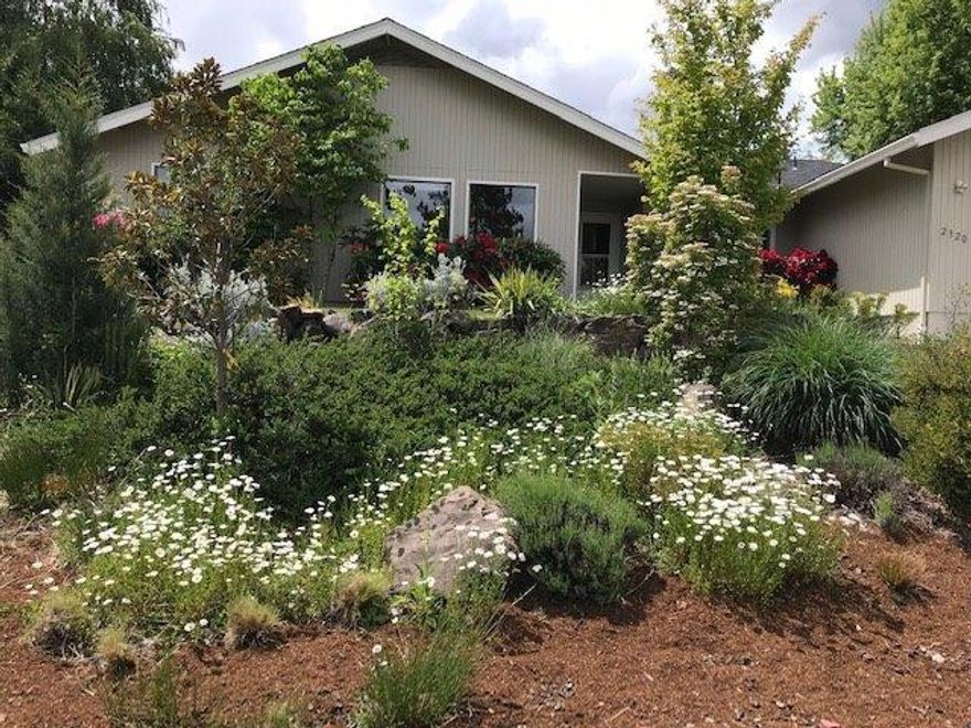 Lovely single level home with open floor plan, lots of natural light and beautiful oak floors throughout with elegant walnut inlay. Granite tile counters in kitchen, gas fireplace in family room, drop in tub, and custom tile in the guest bath, teak counters, walk in shower in the master bath, and heated floors in baths. Also a private outdoor shower and room for a hot tub. Professionally landscaped yard with berries, fruit trees and grapes backs to spacious and usable open space. TID irrigation. The Mountain Ranch neighborhood is much loved and sought after for good reason - an extensive system of enjoyable greenways to walk, underground utilities, wide streets, big lots, and easy access to extensive forest trails.