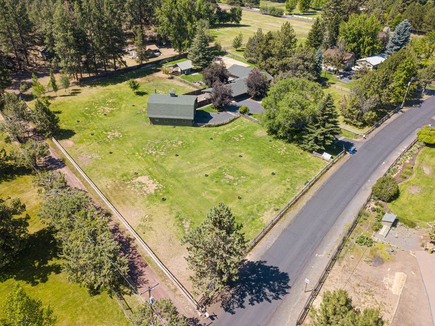 Quiet, private, country life close to town. This location cannot be beat! A stunning 2.1 acre property located just under a 4 mile drive to Downtown Bend, mere blocks from the 184 acre Riley Ranch Reserve, and approx.1 mile to Sawyer Park and the Deschutes River trail system connecting to the Downtown Bend area. This single level, beautifully styled home with character has you feeling like you're home the moment you drive up. Fantastic separation of living space: one wing includes the vaulted family room, large vaulted master suite, dining area and kitchen; the other wing of the home includes a warm, inviting living room with wood burning fireplace, jr suite, bedroom and den/possible 4th bedroom. There is an attached 3 car garage plus a detached 1440 square foot 3 bay shop with office area . The yard is completely landscaped and fenced with a beautiful deck, hot tub, fire pit, and artist studio that is plumbed for water and toilet. Two fenced pastures, 2 acres in ground irrigation.