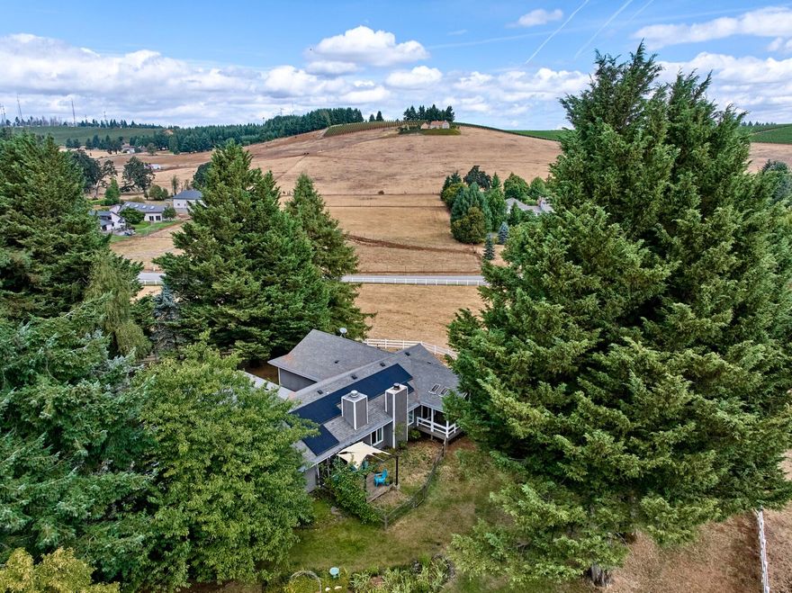 Well placed 5.15 acre property located in the prestigious Chinook Estates of South Salem! With an out of town feel but just minutes to commercial street or downtown Salem, this property and surrounding neighborhood has a unique peace about it. If you're looking for space and a sanctuary out of the cramped, busyness of the city this place has it all. The 2336 sqft home has a private feel as it is nestled among beautiful trees that are well placed around it providing cozy sitting areas to take in the magnificent views of the property and neighboring land. With vaulted ceilings and adequate window size and location the home has a bright and warm appeal. Step out of the master bedroom onto your own private deck for a nice sitting area with great views of the yard and pasture. Energy cost is super efficient now with the new solar system that helps to keep the electric bill lower. The utility room has adequate storage and a deep sink to keep project messes out of the kitchen. Horse fenced.