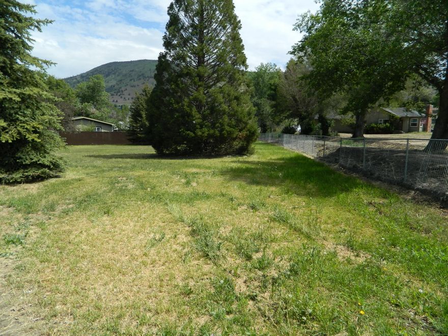 Large .42 acre suburban lot with public utilities at the street