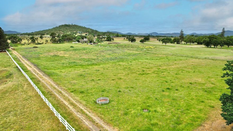 Prestigious 10.89-acre land on Modoc Road, well known for Horse Ranches, Farms, Vineyards and gorgeous properties that follow the Rogue River. Zoned EFU with irrigation rights from the Rogue River. Close to the Medford Airport. Gated and fenced for livestock and security. Bring your plans and purchase this beautiful property with amazing views. Enjoy fishing and rafting on the Rogue River, hiking Table Rock, boating at Lake of the Woods and Lost Creek Lake. The land is a flat, usable and lightly rolling property for hay or other crops that you may be interested in cultivating. There are no active wells or septic systems on this parcel. This land can also be purchased in conjunction with a connecting 10.02-acre Rogue River Front property with a year-round creek, a shop and a Mobile home with well, septic, power and roads (see listing for 12240 Modoc Road #A). Realtor must accompany all potential buyers for access. Buyer to perform due diligence for construction and uses of the property.