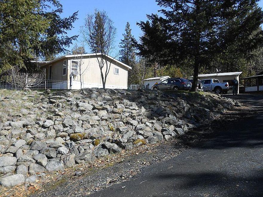 Property backed by BLM. Includes a 700 sq. ft cabin that can be used as a living space while you build a new home or rented. There is a shop for tools, a small chicken coop, and a small animal barn. There is a large area for pasture, hemp, many opportunities. Decks on both the cabin and main home provide space to listen to the crickets chirp in the evening.