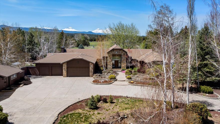 A Tumalo estate on nearly 10 acres with unobstructed Cascade Mountain views. This equestrian property features over 9 irrigated acres, 4-stall barn, paddocks, outdoor arena, RV storage, hay storage, workshop, and 5 garage stalls. Includes 3 irrigated pastures, runout stalls, and a heated tack room. A grand entryway with two creek-style water features, and a large circle driveway leads to the main home. The entryway offers large vaulted ceilings with expansive windows and sweeping views of the koi fish pond, pastures, and Three Sisters mountains. The kitchen includes granite countertops and a spacious bar-style island while the primary suite offers a three-sided fireplace, en suite with a double vanity, tile shower, full bath tub, and a private deck overlooking the mountains. Serene pathways, and a gazebo, green house, and outdoor garden. 1/2 mile to unlimited public lands and trails. Just minutes from downtown Tumalo, this private retreat offers both convenience and tranquility.