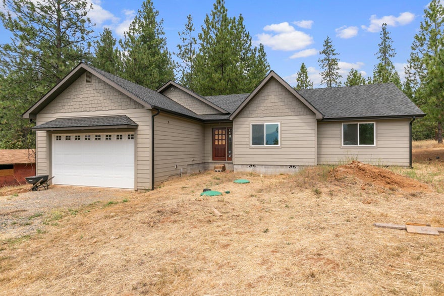 HOME PARTIALLY Constructed. Fire destroyed original home and seller needs to move on from rebuilding. Approx. 40-80k to finish trim-out phase depending on choice of countertops, flooring and fixtures.. Choose your own flooring, cabinets, fixtures.. 2 septic systems and 2 wells . Use for RV hookups.. . Also a 20x40 enclosed pole barn. North side of property excavated and tiered with amazing views of mountains, perfect for an ADU or other outbuildings. Seasonal creek runs though property. Minutes to downtown, shopping and restaurants. CASH SALE