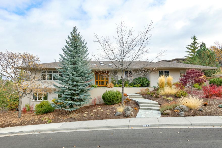 Stunning contemporary home located in the desirable Strawberry Meadows subdivision.  Dramatic views of the surrounding mountain ranges and valley below.  Gracious home with a melding of quality materials and finishes throughout; gorgeous birch floors, travertine, rift-sawn cherry cabinetry, straight grain fir floors and trim just to name a few.  Well thought out floor plan allows for single level living, including the primary bedroom en-suite and an office (or 5th bedroom).  Open floor plan with lots of windows allows for an abundance of natural light.  Spacious deck for enjoyment of the outdoors.  Downstairs has two additional bedroom suites, a versatile room (as 4th bedroom or exercise room) and a family room with access to the backyard.  The grounds are tastefully landscaped w/ various trees, plantings, patios and gardens.  Solar panels to help reduce electricity costs.  Hiking trails are literally in your backyard.  This is an amazing home that should not be missed.