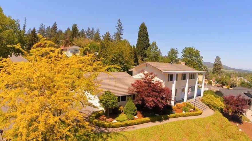 Fantastic colonial style Jacksonville home with huge yard and views of vineyards, Mt Mcloughlin and the table rocks! This absolutely immaculate property has been meticulously maintained inside and out and is the perfect home for entertaining guests. House features a large kitchen, separate living and dining areas, comfortable back porch, cozy gas/wood fireplace, 3 bedrooms and 3 bathrooms, lots of storage, and a bright and cheery feel. Outside you'll find gorgeous landscaping, custom raised garden beds, backyard fountain, 2 car garage with an additional RV Bay, hardie plank siding, and total backyard privacy. All that plus a very functional floor plan, newer carpet, window coverings, fresh paint, large master suite, and wonderful Jacksonville location makes this home a must tour. Home is located minutes from downtown Jacksonville, shops and the Britt Gardens, 15 minute drive to Airport and Medical facilities. Open house on July 15th from 1-4pm.