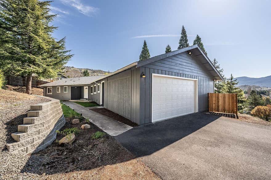 Views! Views! Views! Spacious single-family home located in the highly desired Eastside of Medford with fabulous views.  This single-family home is solidly built with recently updated kitchen & bathrooms with granite counter-tops, stainless-steel appliances & tile back-splash, plenty of storage and nice laundry room.  Features 3 bedrooms, 3 bathrooms, large primary bedroom w/2 walk-in closets, large, tiled shower, spacious living-great room that's bright & open w/lots of windows to enjoy the view, you'll love the updated kitchen with lots of cabinets, eating bar, granite counters tops. Situated off the main road w/ paved driveway, finished 2 car garage w/small storage room or shop. A breezeway that leads to a large, covered deck perfect for entertaining & enjoy the view from your deck year-round.  Contact listing agent to view this awesome home.
