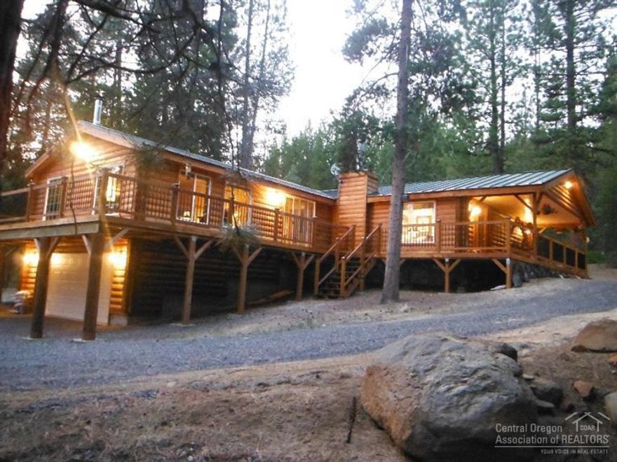 Sellers very motivated! DON'T Pass This Up! 2 Acres! Turn Key! A one-of-a kind log-sided hybrid cabin in excellent condition. Two master suites, large family room with wood stove and a separate living room with fireplace. Sleeps 8 comfortably. Interior upgrades: all wood doors, custom trim, tiled entries. Exterior: newly finished decks with aluminum slates, attached garage, large carport/shop with powered winch, small shed w/ roll up door, exterior lighting & graveled drive. SB360 compliant