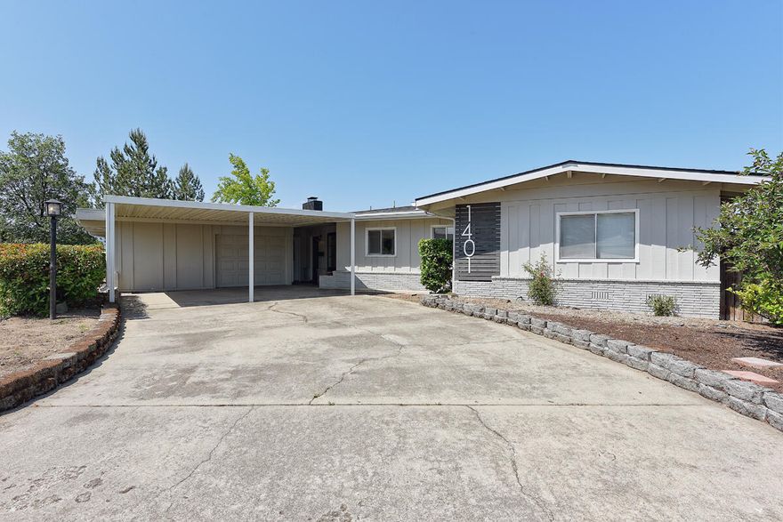 Check out this move in ready mid-century home which is centrally located on a corner lot in Northeast Medford, close to the Hospital and schools.  Very clean, open floor plan, recently updated with fresh paint inside and out. Laminate floors throughout, large kitchen island with granite counter tops, subway tile and breakfast bar with dining room for formal or casual entertaining.  Panoramic windows in the back of the house provide lots of natural light in the living room featuring the brick wood burning fireplace. Private bedrooms on opposite side of the living space. Three sliding doors opens up to an expansive covered deck perfect for summertime bbq's and parties. Very low maintenance yard, with plenty of front driveway and off street parking.  Come see it!