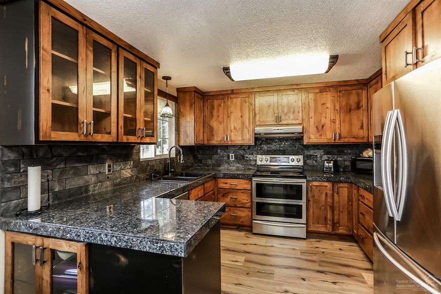 Completely remodeled in 2017, this single level home is on a large 3/4 acre lot in town. This 3 bedroom, 2 bathroom home has laminate wood floors through out, wood burning fireplace, new kitchen cabinets, stainless steel appliances and granite tile countertops. Guest bathroom has travertine tile floors, granite countertops, new large bathtub with tile walls and updated fixtures. Master bathroom has heated tile floors, new large bathtub with tile walls, granite countertops and updated fixtures. Backyard has a large deck with a fenced off grass area and storage sheds. Owner was originally planning on building a casita on the property and has the plans from the builder available. Plenty of space to either move forward with the casita build, add on to the home or to build a shop! Call today for your showing!&nbsp;<div><br></div>