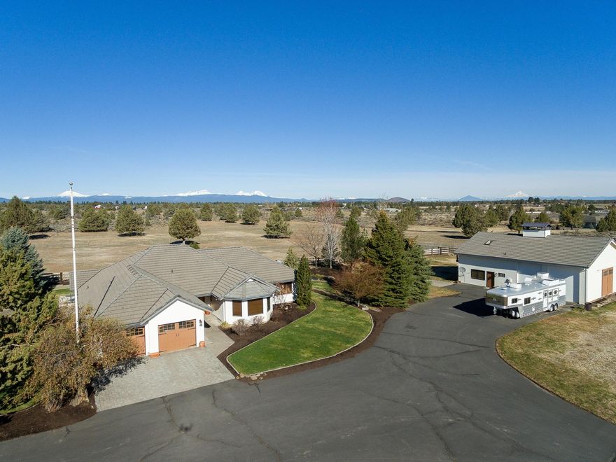 Price reduced!!!  One of a kind, this beautifully manicured 19 acre Equestrian Property has panoramic Cascade Mountain views, 6.5 acres of Arnold irrigation and a detached Carriage House/RV garage. Warm and inviting, the single level ranch home features a grand river rock fireplace, authentic barn wood flooring, new carpet and knotty alder door and moldings throughout. Recently updated kitchen (2019) is light and bright with white shaker cabinets, quarts counters and new appliances. Equestrian amenities include a 4- stall barn with paddocks and turnouts, wood paneled heated tack room, a 200 X 200 outdoor arena, fenced and cross fenced with high quality wood and no climb fencing, dry hay storage, equipment storage, 2 loafing sheds. The Carriage House Suite adds another 1,400 ft.* of finished living space with bathroom, office, common area, bonus room and fireplace. Huge 900* sq ft. heated attached shop with double RV bays.