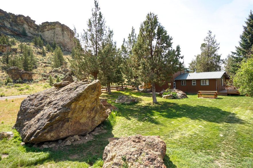 30 acres at the base of Smith Rock... tucked way back from the road you'll find the ultimate privacy! 3 bedroom house w/bonus room/4th br is perfect to live in while you build your dream home. Amazing views of the Cascade mountains & Smith Rock. Riding/roping arena, barn, shop, storage shed & much more. 10 acres of flood irrigated pasture. Fenced & ready for your horses!