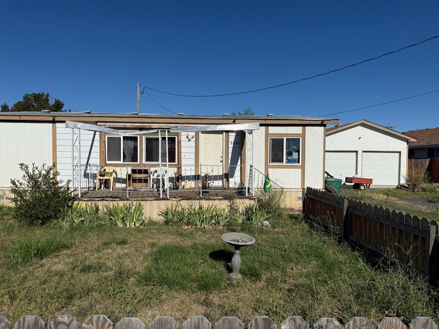 Back on market no fault of property. Being sold AS IS. Needs lots of TLC. Set on .43 acres, this property offers endless potential. The existing 1979 manufactured home features 2 bedrooms, 2 bathrooms, and approximately 1,080 sq ft, along with a 2-car garage—perfect for storage, tools, or a workshop. With Medium Density Residential zoning, you have flexibility to renovate and add your personal touch, or remove and rebuild to maximize the lot's potential. This is a fantastic chance for investors, builders, or buyers ready to put in some sweat equity. Conveniently located with easy access to town amenities, this property is ideal for those seeking affordability and opportunity in today's market. Whether you're dreaming of a fixer-upper project or envisioning new construction, this one delivers options and value. Don't miss the chance to turn this diamond in the rough into your next big win! Very motivated seller says bring all offers.