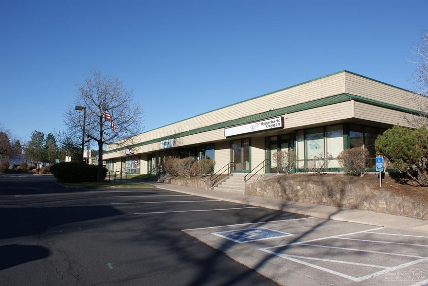 Building totals 53,877 square feet of rentable area with 37 suites and has Hwy 97 frontage. Block construction with framed frontage allows a variety of uses. Single entry fronts with several suits have double door entry and/or roll up doors to the back parking area.