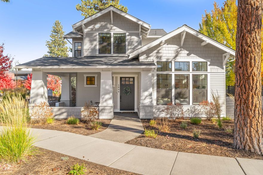 Charming Craftsman-style home in the heart of Northwest Crossing. This impeccably maintained beauty offers 3 bedrooms, 2.5 baths and 2,047 sq ft of bright, open living. The vaulted great room is filled with natural light and features a gas fireplace with a custom mantel and tile surround. Wide-plank hardwood floors flow through the main level. The chef's kitchen impresses with a large island, slab quartz counters, stainless commercial-style range, refrigerator, and spacious pantry. Main-level primary suite is a peaceful retreat with a beautifully tiled bath. Upstairs offers two bedrooms, full bath, and a bonus area with built-in bar. Enjoy covered patios in both front and back yards. Low maintenance turf & pavers in the private side yard. Water-efficient landscaping. Fresh interior/exterior paint. Epoxy garage floors. Located just steps from Discovery Park, trails, dining, and shops. Energy-efficient construction and timeless curb appeal make this home a true standout.