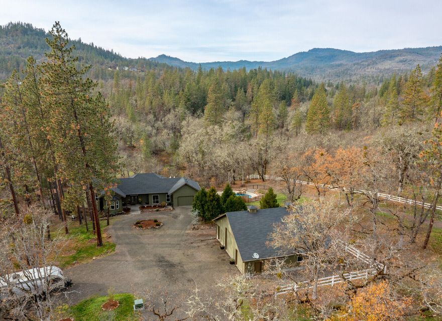 It's rare when a property this comprehensive, this unique, this incredible comes along! A 3,434 SF custom home, 42 x 40 shop/RV barn, detached 280 SF office/rec room with heat and a/c, custom saltwater pool, hot tub and water feature, sport court, RV parking, timber framed gazebo and much more! It's all privately situated with gated access on two 10+ acre tax lots for a total of 20.74 acres of mixed terrain and foliage; it's perfect for walking, trail riding or simply enjoying nature! The 5 bedroom custom home was built with an ICF foundation system, 2 master suites, dual climate control central HVAC plus a wood fuel radiant heating system, central vac, a lower level patio and full-length main level Trex deck. It's truly a spectacular setting, packed with value and conveniently located with easy access to communities throughout the Rogue Valley, and yet just minutes from the Rogue River. It's an absolutely perfect place to call home! Inquire for a detailed information packet.