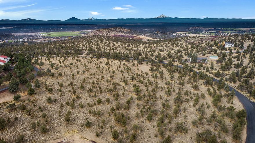 This 4.54-acre homesite perfectly captures what people love about living in Central Oregon, with endless views, fresh air, and room to breathe. Set in the quiet Mountain Shadows community, the land gently slopes to reveal stunning vistas of Smith Rock and the Cascade peaks. Paved access, a beautiful mix of trees, and the peace of open space make this the ideal setting for your future home. Directly across the road is more than 120 acres of public land, perfect for exploring, hiking, or added privacy. Build here and enjoy the best of country living with convenience close by.