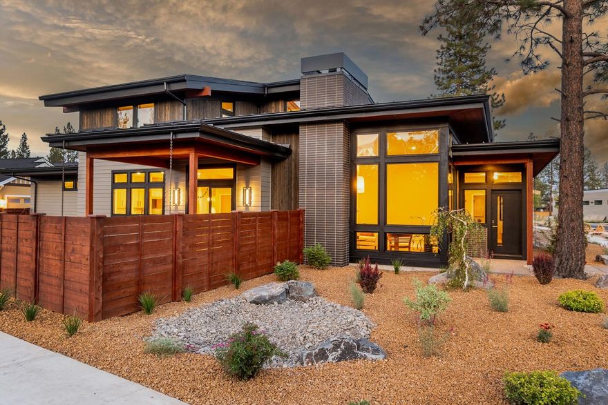 Recently completed custom home in desirable Discovery West by award winning Leader Builders. Enjoy the open concept floor plan & kitchen featuring Quartzite natural stone counters, professional level appliances, rift sawn white oak flush inset cabinetry, & more. Thoughtfully placed south & west facing windows light up the 16' tall great room w/ gas fireplace & built-ins, as well as spacious dining area w/ slider access to large covered patio + fenced & landscaped yard. Main level primary suite w/ custom barn door accessing the ensuite bath includes a gorgeous tile shower w/ recessed lighted storage shelf & dual shower heads. The main level also includes a conveniently located den, powder bath w/ live edge counter, & laundry room w/ sink + folding table. Upstairs find two additional guest bedrooms, guest bath, & open flex space perfect for a variety of uses. With an abundance of luxurious features & quality construction, this contemporary masterpiece is an absolute must see in NW Bend!