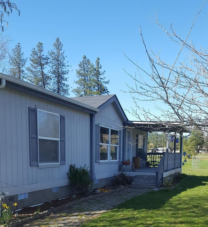 If you're looking for wide open spaces, sunny and with views this is IT!! Enjoy your coffee at sunrise on your covered front porch. Two acres with potential for your horses and/or other furry pets or just enjoy the greenery! Private Setting but, not secluded and only about 5 miles into Rogue River. This lovely 2007 Mfg. home is spacious light & bright. Open floor plan with kitchen and Living Room adjoining. Kitchen is equipped with all applc's and island. New laminate flooring. Vaulted ceilings. Laundry is located off kitchen . Storage is abundant. This property is well taken care of with a circular drive and water feature . Detached two car garage with room for small shop area and storage. You'll love the mountain views and open feel of this well maintained home. Easy to show!