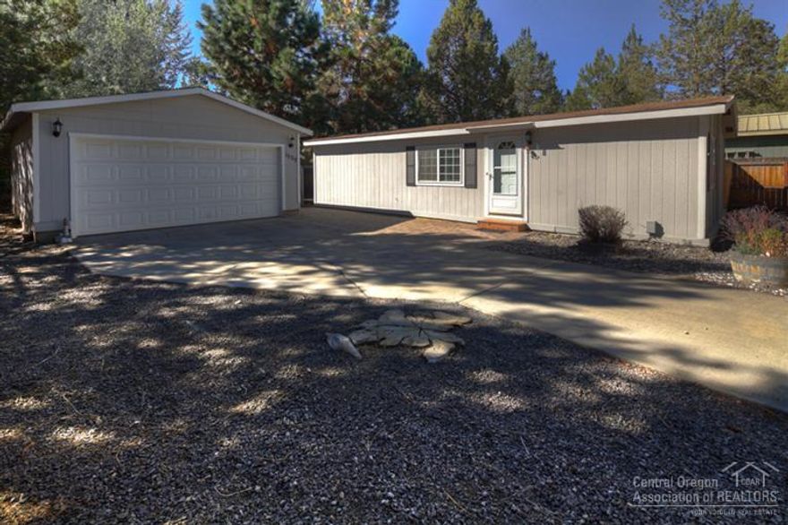 Beautifully updated & well maintained single level home! Park like setting with mature trees. Great room with vaulted ceiling. Kitchen & eating area with new laminate floor. Master bedroom with vaulted ceiling. Master bath & hall bath with new flooring & cabinetry. Second bedroom with large walk-in closet. Utility room with built-in cabinets. Oversize detached double car garage plus storage building. Spacious paver patio in front of home. Convenient location to shopping, parks, trails & Bend Senior Center.