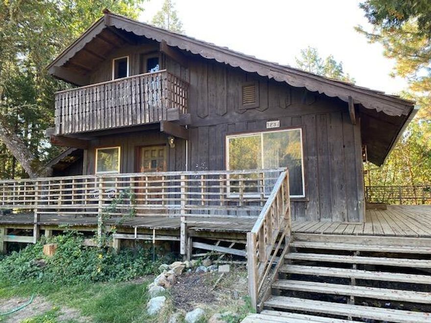 Looking for a unique mountain get away in Sunny Valley? Look no further! Relax, unwind, and stroll through 10 private, peaceful acres. Numerous walking trails to enjoy on this breathtaking property, bordering a creek-fed pond with several sitting areas. Three outbuildings: large barn, shed, & cottage. Spring flows year round. 24 tree orchard including several varieties of apples and pears, plum, & walnut trees. Fenced garden area and chicken pen. Property is majority fenced with BLM land bordering two sides of the property. Come tour this lovely oasis today!