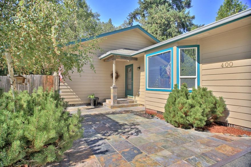 This contemporary country style Rancher style home with a paved circular driveway has everything on your list. Just minutes from Grants Pass, situated on just over 1/2 acre this well appointed 3 bedroom, 2 full bath home features single level living, a beautiful slate patio porch entry, vaulted ceilings, interior plant shelving and a large bay window, and a convenient kitchen counter bar with deck access off the kitchen. The master bedroom features a vaulted ceiling, with walk-in closet, a dual sink bath with shower, and cultured marble and private deck. The large yards are well established and fenced. There's a huge Gazebo set up for outdoor BBQ'S and family get-togethers. The large gated RV parking allows for additional parking, and there's a bonus 12x20 shed great for storage. This is a special property come see it today!