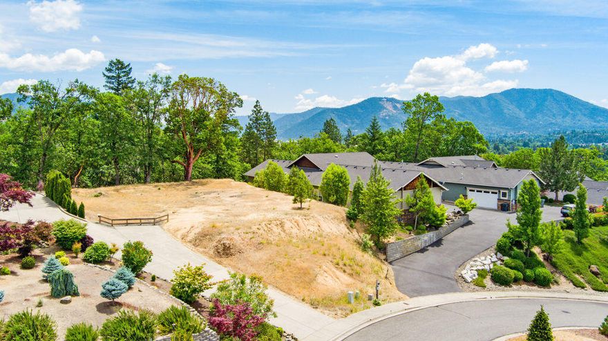 Build Your Dream Home with Stunning Sunset Views!  This exceptional .31-acre lot is ready for your custom home, offering breathtaking views to the west of the mountains and valley—perfect for enjoying those Southern Oregon sunsets. Nestled in the desirable Forest Hills Subdivision, just on the outskirts of town, this property backs to open space, providing a natural backdrop. Utilities including city water, sewer, and natural gas are available at the street, streamlining the building process.  Build your dream home in a desirable neighborhood that balances privacy and convenience—just minutes from the heart of downtown, boutique shopping, local dining, healthcare, and more.  Ready to build? Start designing—this lot is waiting for you!
